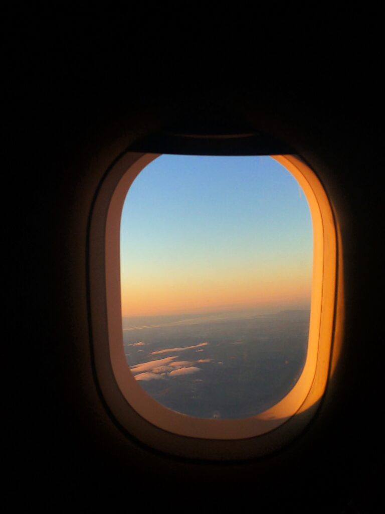 Sunrise through a plane window on a long haul flight. 