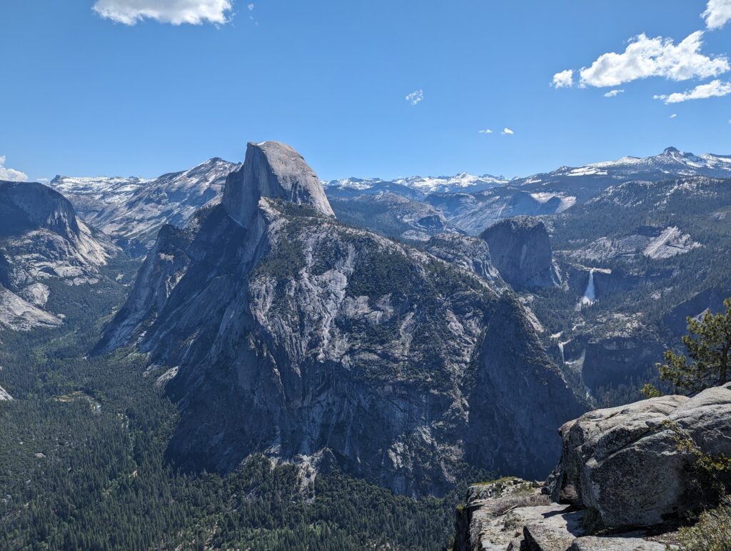 Spectacuar birds-eye view of snow-topped mountains and Yosemite Valley from Glacier Point. 